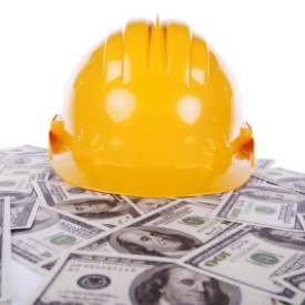 BIG STOCK: Hard Hat on a pile of 100 Dollar Bills